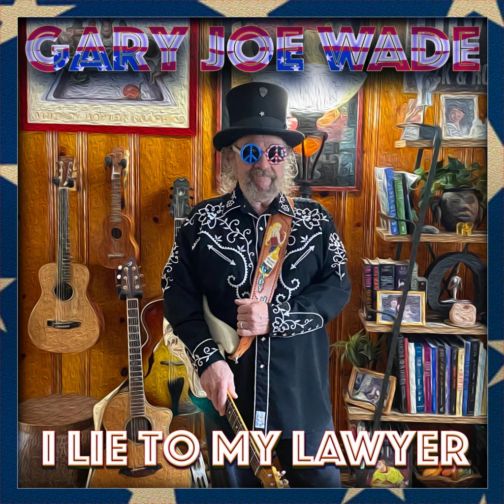 Man in black embroidered jacket and top hat holding electric guitar in music studio with instruments and bookshelves